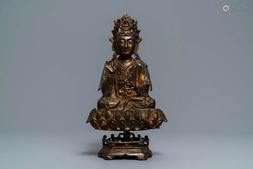 A Chinese gilt-lacquered bronze figure of Guanyin on a lotus throne, Ming