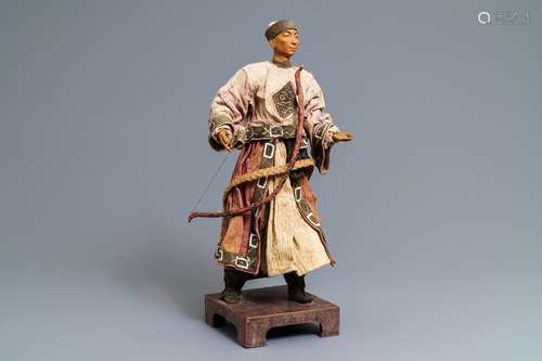 A Chinese Manchu archer doll in painted wood and textile, 19th C.