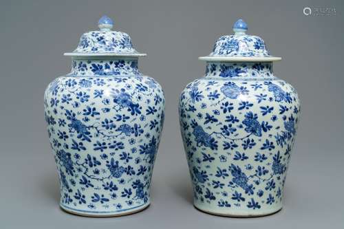 A pair of Chinese blue and white covered vases with floral design, Kangxi