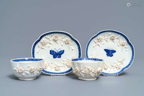 A pair of Chinese blue and white 'soft paste' relief-decorated cups and saucers, Qianlong