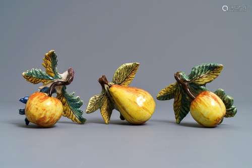 Two polychrome Dutch Delft models of apples and one of a pear, 18th C.