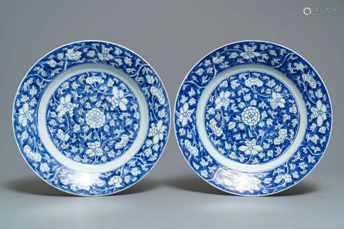 A pair of Chinese blue and white 'flower scroll' dishes, Kangxi