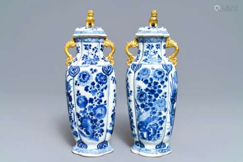 A pair of Chinese blue and white covered vases with floral design, Kangxi