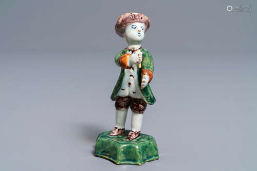 A polychrome Dutch Delft figure of a boy with a hat, 18th C.