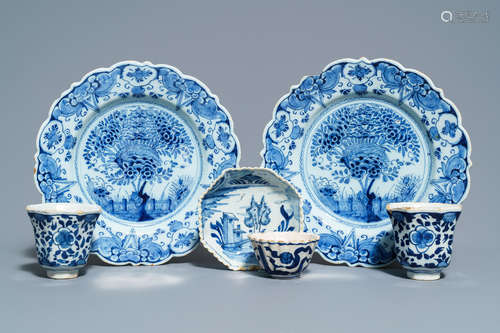 A pair of Dutch Delft blue and white plates, three cups and a saucer, 18th C.