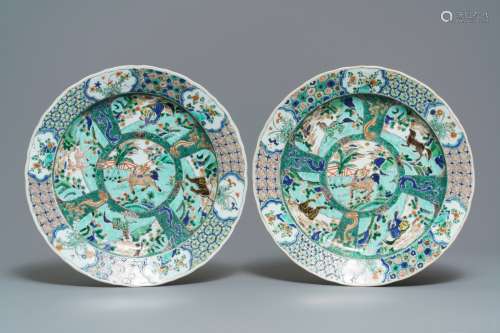 A pair of Chinese famille verte 'mythical beasts' chargers, Kangxi