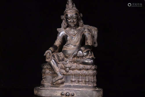 A BLACK STONE CARVED BUDDHA SHAPED ORNAMENT