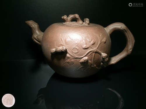 A ZISHA TEAPOT WITH SQUIRREL PATTERN