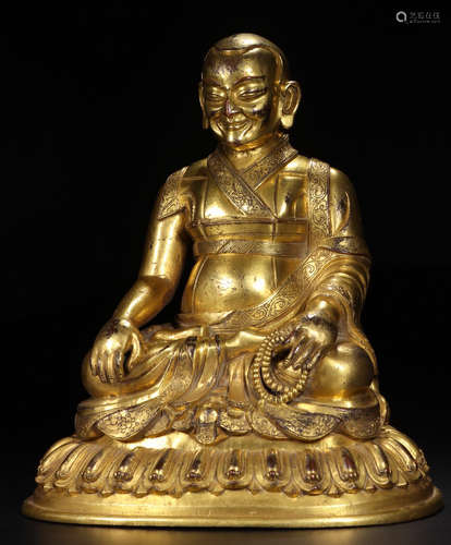 A GILT BRONZE SHAPED SITTING MONK BUDDHA