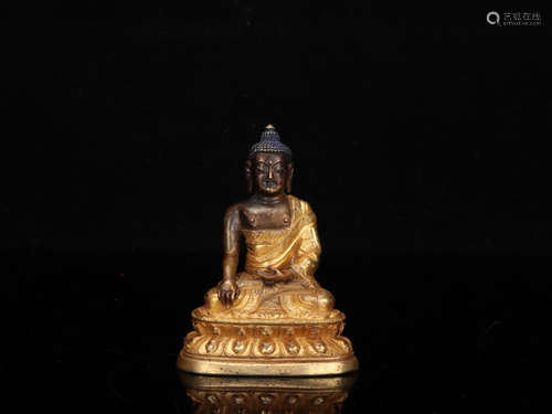 A GILT BRONZE BUDDHA SHAPED ORNAMENT