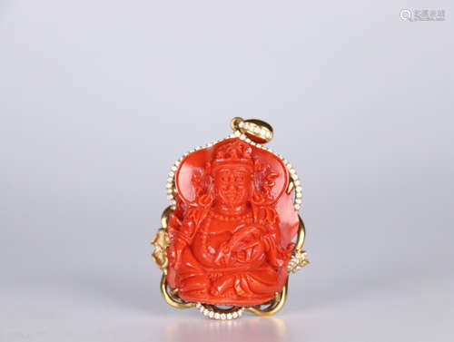 A RED CORAL BUDDHA SHAPED PENDANT EMBEDED 18K GOLD