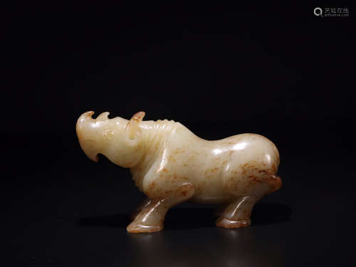 A HETIAN JADE ORNAMENT OF RHINOCEROS SHAPED