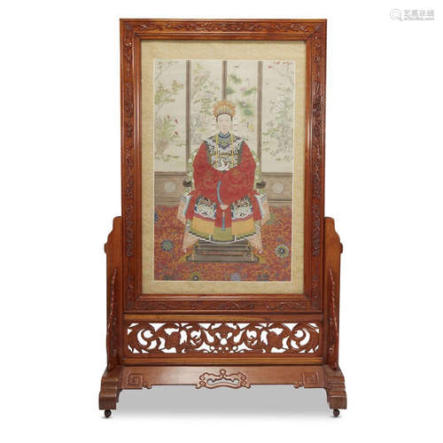 A Chinese portrait of a seated female figure, mounted in a carved and stained hardwood floor screen