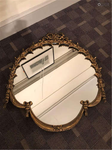 An ornate gold mirror