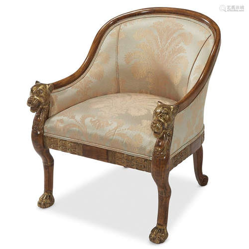 An Egyptian Revival style upholstered armchair