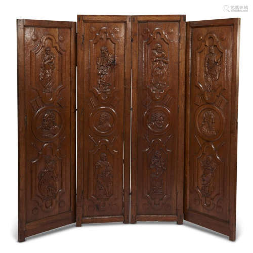 A GOTHIC REVIVAL CARVED WALNUT 'APOSTLE' FOUR PANEL FLOOR SCREEN