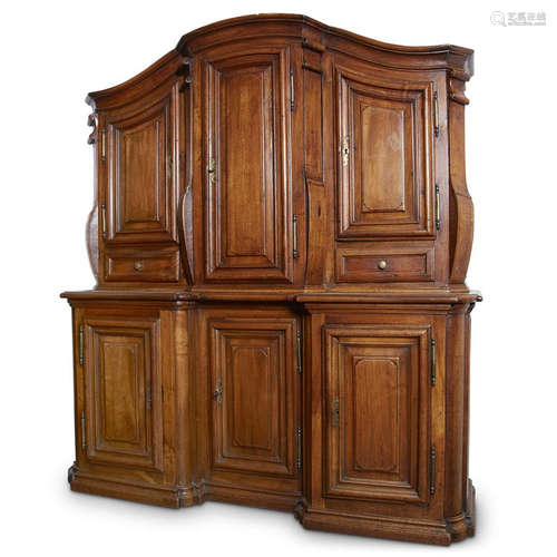 A Continental Baroque style walnut paneled cupboard