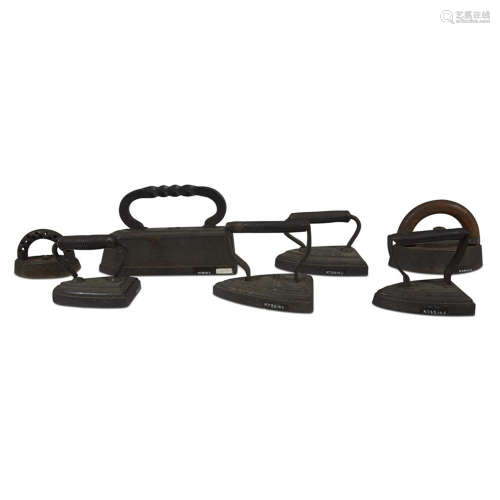 A collection of seven cast irons