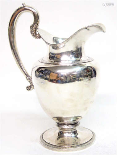 A silver water pitcher