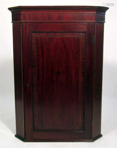 A George III inlaid mahogany hanging corner cupboard