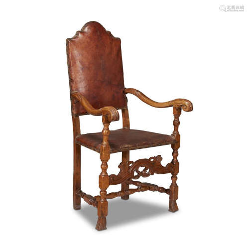A CONTINENTAL BAROQUE CARVED WALNUT ARMCHAIR