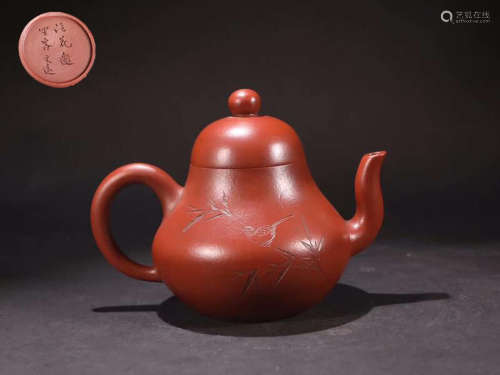 A ZISHA TEAPOT WITH CARVING AND MARKING