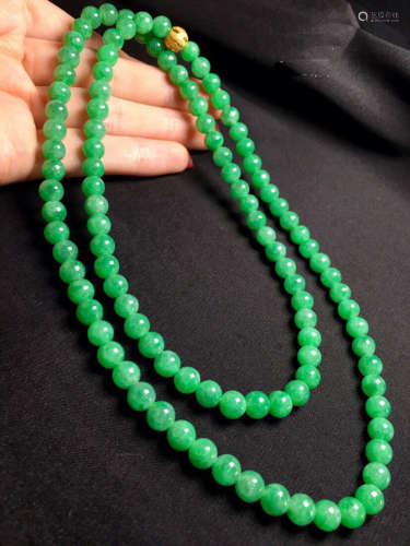 A NECKLACE MADE OF GREEN BEADS
