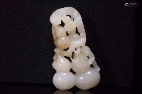 A HETIAN JADE ORNAMENT OF MONKEY AND GOURDS