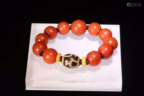 A TIBETAN BRACELET MADE OF RED AGATE BEADS AND DZI