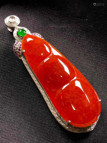 A RED JADEITE PENDANT OF LUCKY BEAN