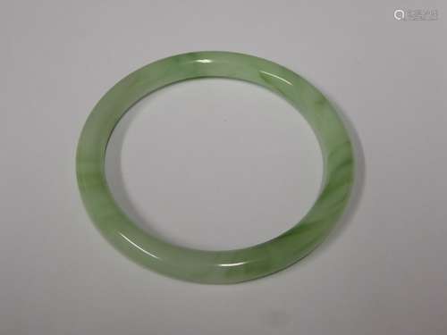 A Chinese Apple Green Jade-Style Bangle, approx 6 cms diameter, together with a coral-strand necklace approx 38 cms and a carnelian style ring