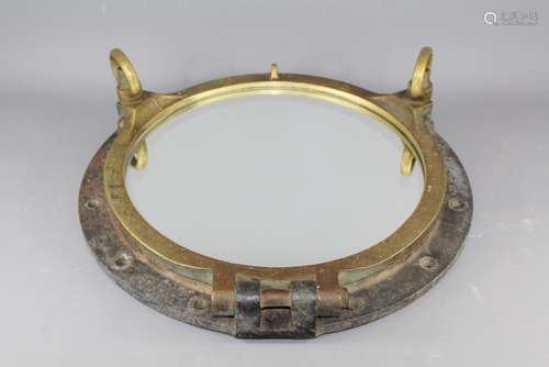 An Original Brass Ship's Portal (now mirrored) for decorative purposes, approx 58 cms d