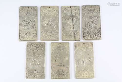 Seven Chinese Silver-Metal Scroll Weights, embossed decoration depicting the Chinese horoscope and the animals of the Zodiac