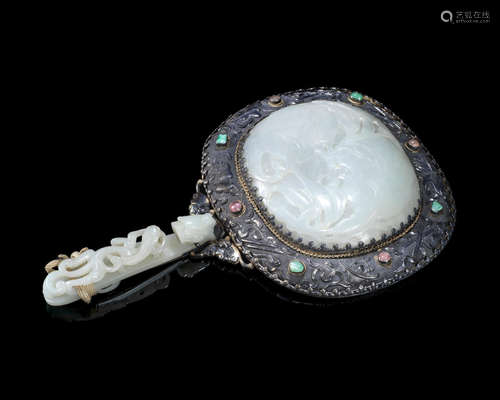 The jade 18th/19th century, the silver 19th/20th century A jade and hardstone-inset silver repoussé hand mirror