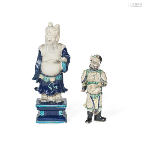 16th/17th century to Kangxi A biscuit famille verte figure of a Guardian King and a fahua-style figure of Lu Dongbin