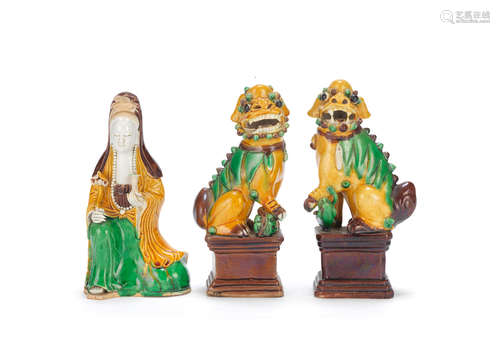 Kangxi A famille verte biscuit figure of Guanyin and a pair of Buddhist lions