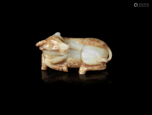 A pale green and russet jade carving of a buffalo