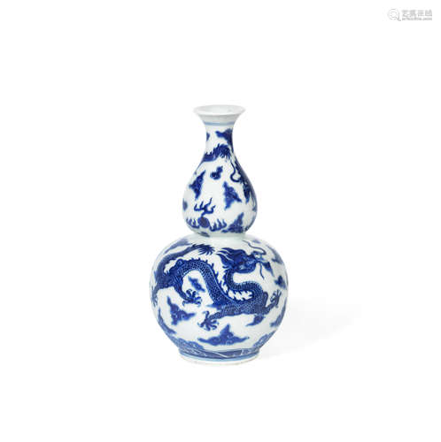 Qianlong seal mark, 19th century A blue and white double gourd form 'dragon' vase