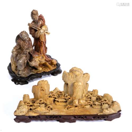Two soapstone carvings Chinese, 20th Century the first depicting a mountainous landscape against a