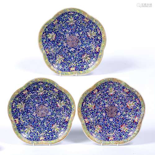 Three polychrome medallion shaped stands Chinese late 19th/early 20th Century of blue ground with