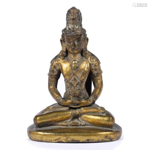 Bronze figure of Avalokitesvara Tibetan, 16th/17th Century seated crossed legged upon a rounded