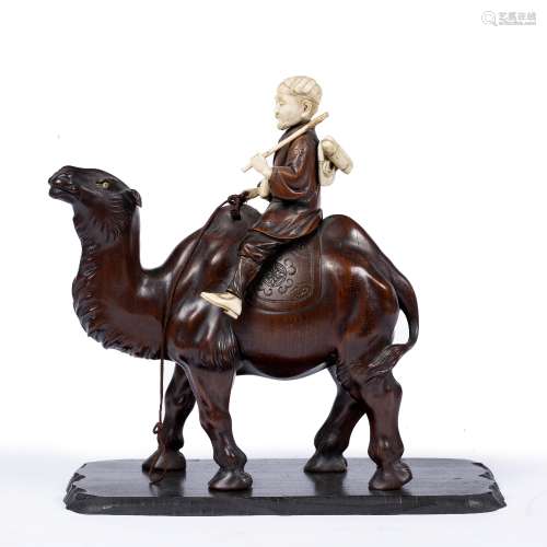 Wood and ivory okimono Japanese, late Meiji carved as a Mongolian traveller astride a camel, the