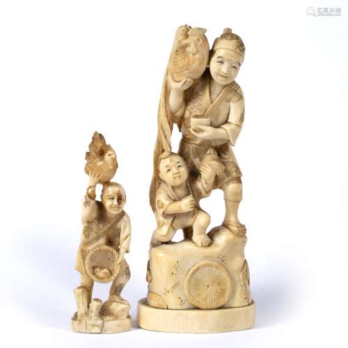 Ivory okimono Japanese of standing figure holding cockerel in his right hand and with crouching
