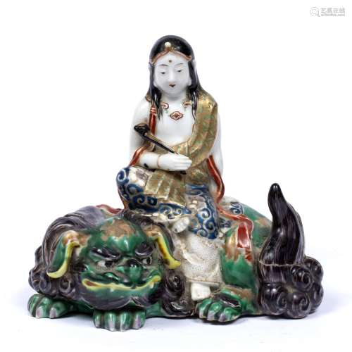 Polychrome porcelain model of Guanyin Chinese, 19th Century the seated figure on a temple dog and
