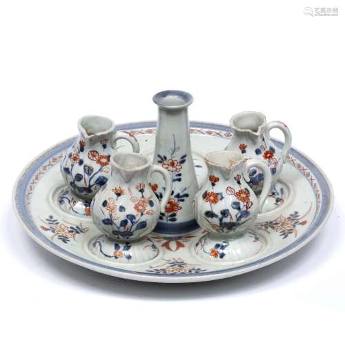 Imari cruet set Japanese, circa 1800 with central tray and four matching jugs, all decorated in iron