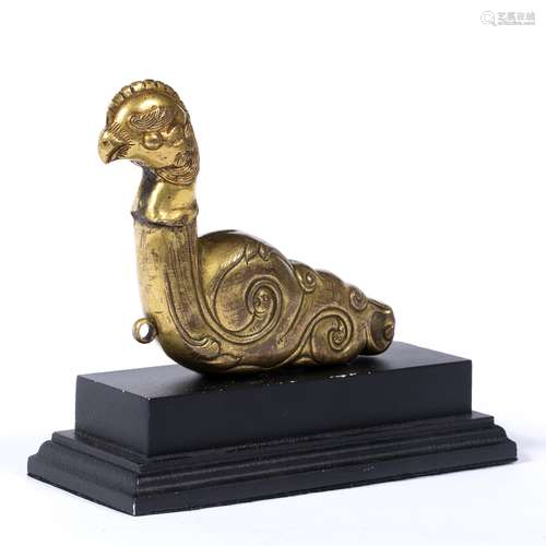 Gilt bronze phoenix Tibetan 18th/19th Century the stylised repousse bird having a scroll body 16cm