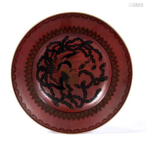 Red lacquered dish Japanese decorated centrally with phoenix in black and red lacquer set against