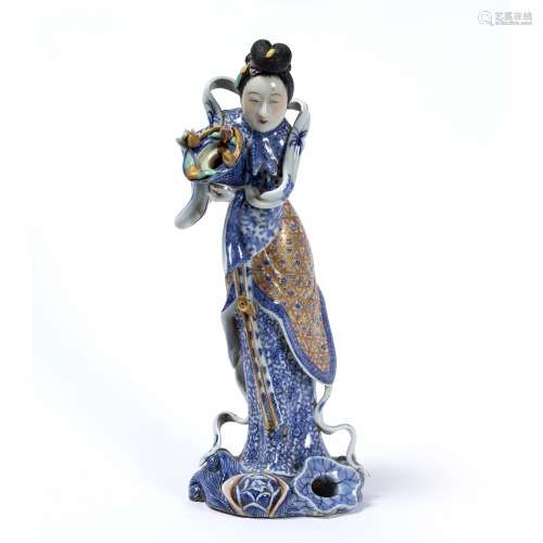 Porcelain figure of a women Chinese decorated in traditional flowing garments holding a conical