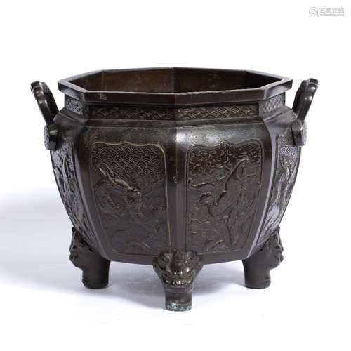 Bronze octagonal jardiniere Chinese, 19th Century with panels of dragons and birds on mask supports,