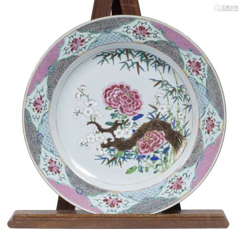 Large famille rose charger Chinese, 18th Century with painted bamboo, peony and blossom within a